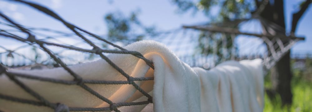 Hammock with cozy blanket demonstrates heart healthy habits like a relaxing vacation mentality